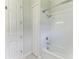 Clean bathroom with white subway tile, shower/tub combo, and linen closet at 12734 Rainwashed Loop, Parrish, FL 34219