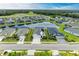 Aerial view of a lakefront community with multiple homes at 12734 Rainwashed Loop, Parrish, FL 34219