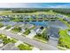 Aerial view of a lakefront community with multiple homes at 12734 Rainwashed Loop, Parrish, FL 34219