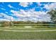 Landscaped park with a pond and a circular seating area at 12734 Rainwashed Loop, Parrish, FL 34219