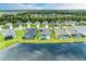 Aerial view of a lakefront community with multiple homes and pools at 12734 Rainwashed Loop, Parrish, FL 34219