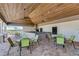 Covered patio area with tables and chairs near the pool at 12734 Rainwashed Loop, Parrish, FL 34219