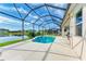 This beautiful screened pool overlooks a serene lake at 12734 Rainwashed Loop, Parrish, FL 34219