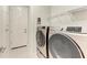 Laundry room with washer, dryer, shelving, and built-in storage at 12734 Rainwashed Loop, Parrish, FL 34219