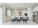 Bright kitchen features white cabinets and granite island at 12734 Rainwashed Loop, Parrish, FL 34219