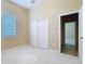 Bedroom with neutral carpet and bi-fold closet doors, illuminated by natural light from a window at 111 172Nd E St, Bradenton, FL 34212