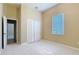 Bright bedroom features neutral carpet, bi-fold closet doors, and a window with natural light at 111 172Nd E St, Bradenton, FL 34212
