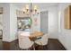 Cozy dining area with chandelier, next to large window overlooking the pool at 16729 Collingtree Xing, Bradenton, FL 34202