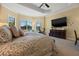 Bright main bedroom featuring neutral colors, and large windows with shutters and a ceiling fan at 16729 Collingtree Xing, Bradenton, FL 34202