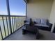 Comfortable balcony features wicker furniture, a view, and plenty of sunlight at 7005 River Hammock Dr # 404, Bradenton, FL 34212