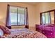 Cozy bedroom featuring a large window and dresser at 7005 River Hammock Dr # 404, Bradenton, FL 34212