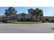 The clubhouse features beautiful stonework and manicured landscaping, with palm trees dotting the grounds at 7005 River Hammock Dr # 404, Bradenton, FL 34212