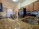 Stylish kitchen featuring stainless steel appliances, granite countertops and adjacent dining area at 7005 River Hammock Dr # 404, Bradenton, FL 34212