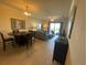 Open-concept living and dining area with neutral tones and tile flooring at 7005 River Hammock Dr # 404, Bradenton, FL 34212