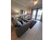 Comfortable living room with couches, area rug, and large glass doors to a balcony at 7005 River Hammock Dr # 404, Bradenton, FL 34212
