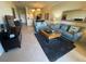 Open-concept living room featuring tile flooring, a plush rug, and comfortable sofas at 7005 River Hammock Dr # 404, Bradenton, FL 34212