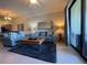 Comfortable living room featuring tile flooring, a plush rug, and modern furnishings at 7005 River Hammock Dr # 404, Bradenton, FL 34212