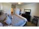 Comfortable main bedroom features a ceiling fan, large bed, and ensuite bathroom entrance at 7005 River Hammock Dr # 404, Bradenton, FL 34212