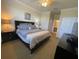 Comfortable main bedroom features a ceiling fan, large bed, and ensuite bathroom entrance at 7005 River Hammock Dr # 404, Bradenton, FL 34212