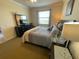Comfortable main bedroom features a ceiling fan, large bed, and ensuite bathroom entrance at 7005 River Hammock Dr # 404, Bradenton, FL 34212