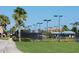 Well-maintained tennis courts surrounded by lush greenery and palm trees at River Strand at 7005 River Hammock Dr # 404, Bradenton, FL 34212
