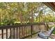 Relaxing balcony with wooded views and a comfortable chair at 1700 Glenhouse Dr # 406, Sarasota, FL 34231