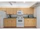 Well-equipped kitchen featuring light wood cabinets and white appliances at 1700 Glenhouse Dr # 406, Sarasota, FL 34231