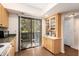 Kitchen with wood cabinets, microwave, and view to a patio at 1700 Glenhouse Dr # 406, Sarasota, FL 34231