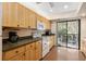 Bright kitchen with light wood cabinets, modern appliances, and laminate flooring at 1700 Glenhouse Dr # 406, Sarasota, FL 34231