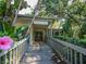 Harbor Club community center with walkway and tropical plants at 1700 Glenhouse Dr # 406, Sarasota, FL 34231