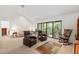 Spacious living room with access to a balcony and hardwood floors at 1700 Glenhouse Dr # 406, Sarasota, FL 34231