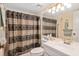 Clean bathroom with shower/tub combo, toilet and vanity at 1700 Glenhouse Dr # 406, Sarasota, FL 34231