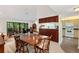 Open dining area with wood table, adjacent to living room and kitchen at 1700 Glenhouse Dr # 406, Sarasota, FL 34231