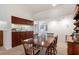 Bright dining room with a wood table and chairs near the kitchen at 1700 Glenhouse Dr # 406, Sarasota, FL 34231