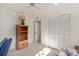 Bright bedroom with double door closet and wood shelving at 1700 Glenhouse Dr # 406, Sarasota, FL 34231