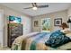 Spacious bedroom with a king-size bed, dresser, and ceiling fan at 4457 Maywood Ln, North Port, FL 34286