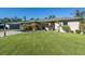 Tan two-story house with a two-car garage and neatly landscaped yard at 4457 Maywood Ln, North Port, FL 34286