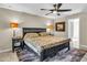 Main bedroom with king-size bed, ceiling fan, and access to the bathroom at 4457 Maywood Ln, North Port, FL 34286