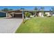 Two-story home with a two-car garage and well-manicured lawn at 4457 Maywood Ln, North Port, FL 34286