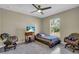 Bright bedroom with tiled floors, ceiling fan, and window providing natural light at 4457 Maywood Ln, North Port, FL 34286