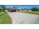 Two-story home with a large driveway and a well-manicured lawn at 4457 Maywood Ln, North Port, FL 34286