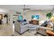 Open living room with two sofas and large TV at 4457 Maywood Ln, North Port, FL 34286