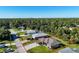 Aerial view of a single-Gathering home with a spacious yard and driveway at 4457 Maywood Ln, North Port, FL 34286