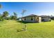 Landscaped backyard offering privacy and plenty of green space at 4457 Maywood Ln, North Port, FL 34286