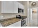 Well-equipped kitchen with granite countertops and stainless steel appliances at 4457 Maywood Ln, North Port, FL 34286