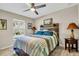 Bedroom featuring a rustic wooden headboard and a ceiling fan at 4457 Maywood Ln, North Port, FL 34286
