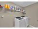 Laundry room with washer, dryer, and shelving for storage at 4457 Maywood Ln, North Port, FL 34286