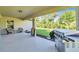 Covered patio features a built-in grill and overlooks the backyard at 4457 Maywood Ln, North Port, FL 34286
