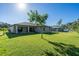 Expansive backyard with a view of the home and surrounding trees at 4457 Maywood Ln, North Port, FL 34286