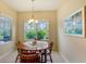 Bright dining room with wood table and chairs, overlooking a tranquil view at 4807 Harvest Grove Pl, Parrish, FL 34219